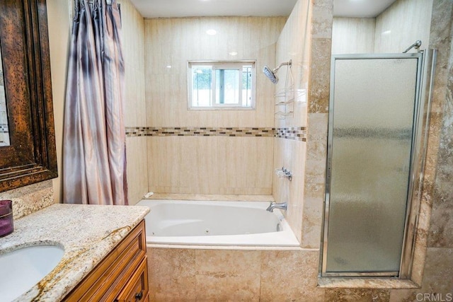 bathroom featuring separate shower and tub and vanity