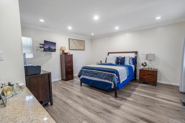 bedroom with ornamental molding and hardwood / wood-style flooring