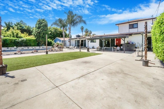 back of property featuring a yard and a patio area