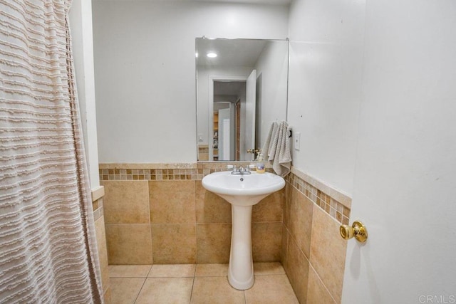 bathroom featuring tile flooring and tile walls