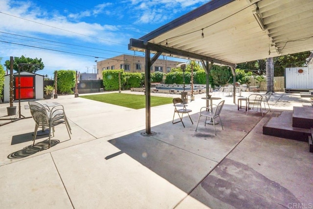 view of patio featuring a shed