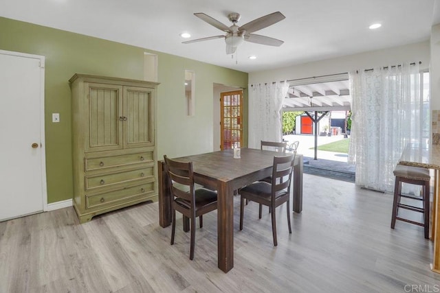 dining space featuring light hardwood / wood-style floors and ceiling fan