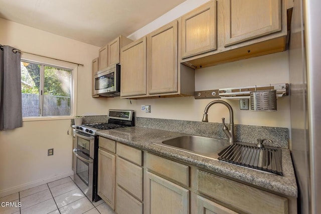 kitchen with light brown cabinetry, stainless steel appliances, light tile patterned floors, and sink