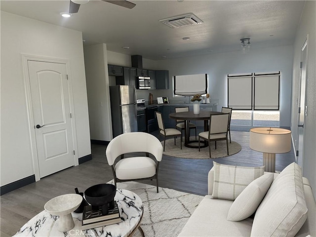 living room featuring light wood-type flooring and ceiling fan