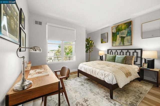 bedroom with hardwood / wood-style floors