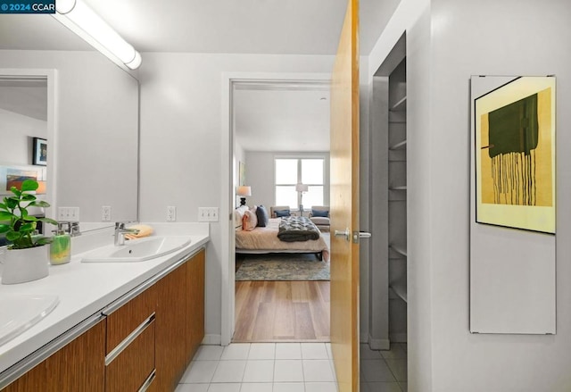 bathroom featuring double vanity and tile floors