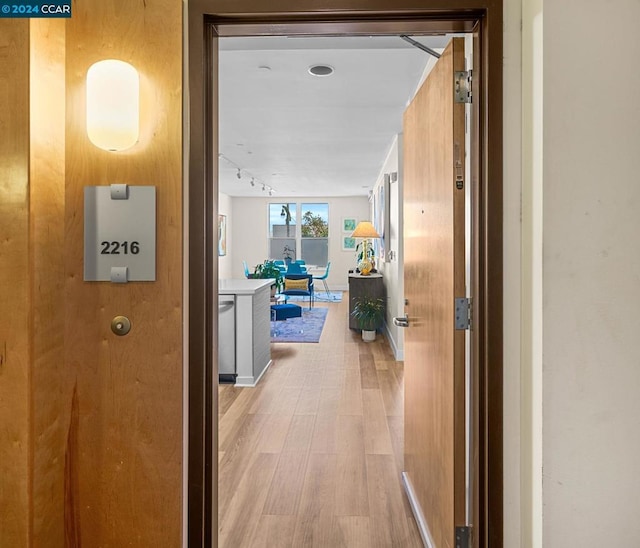 hall with light hardwood / wood-style floors