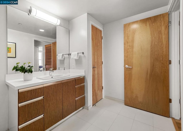 bathroom featuring tile flooring and vanity