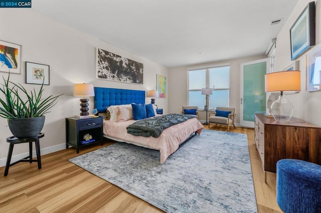 bedroom with light hardwood / wood-style flooring