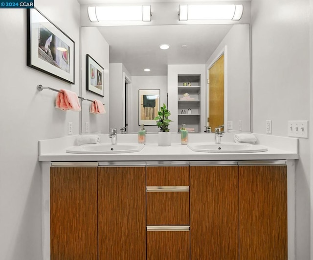 bathroom with dual sinks and large vanity