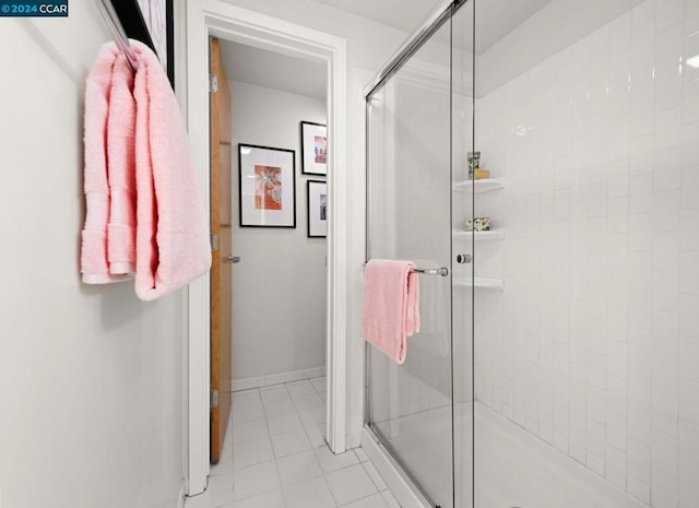 bathroom featuring tile flooring and a shower with door