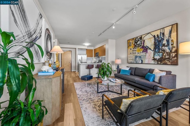 living room featuring light hardwood / wood-style flooring and track lighting