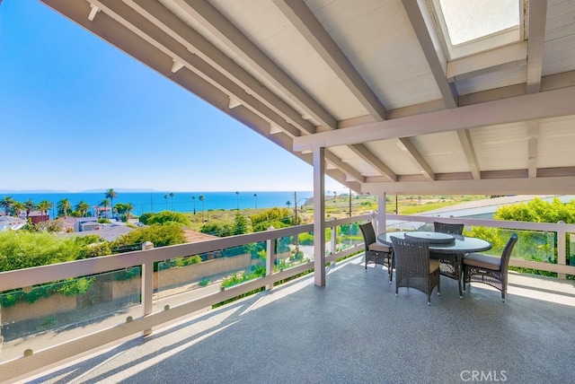 view of patio / terrace with a water view and a balcony