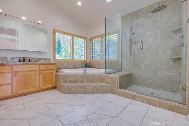 bathroom with separate shower and tub, lofted ceiling, and vanity