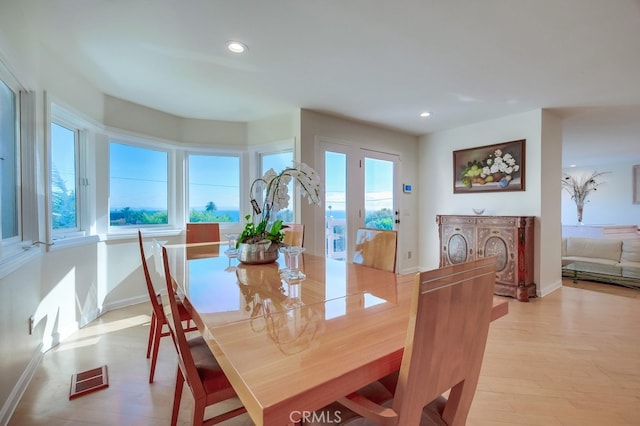 dining space featuring light wood-type flooring