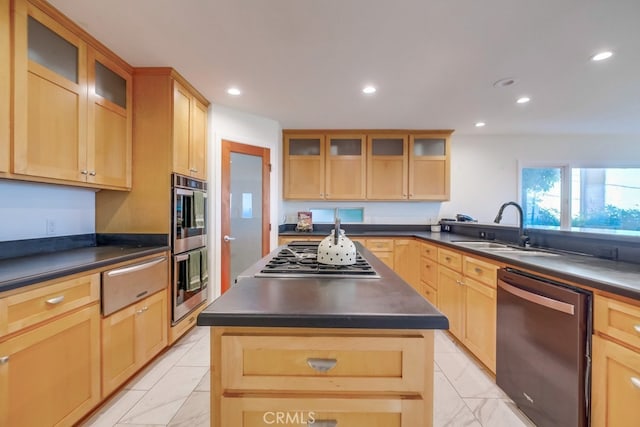 kitchen with appliances with stainless steel finishes, a kitchen island, sink, and light brown cabinets