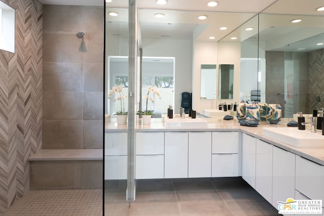 bathroom featuring tile patterned floors, vanity, and walk in shower