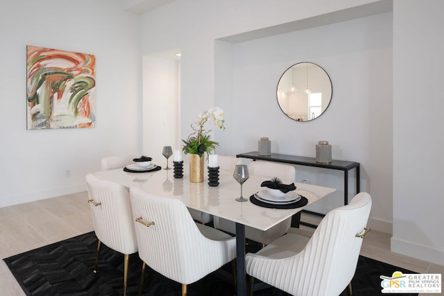 dining space with wood-type flooring