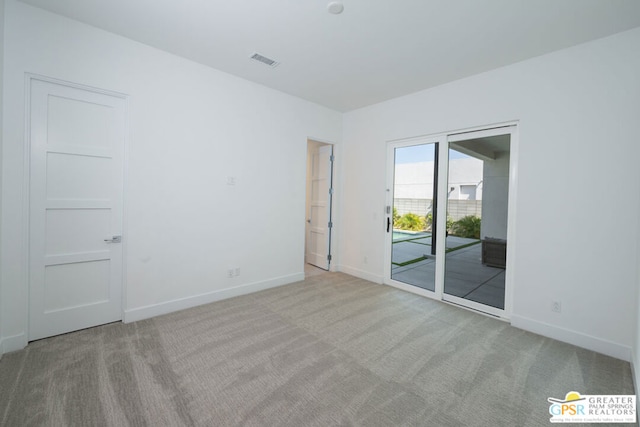 empty room featuring light colored carpet