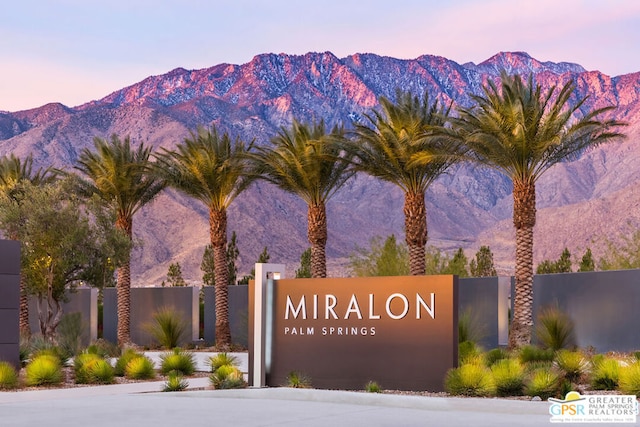 community sign with a mountain view