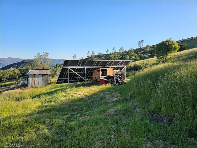 view of stable featuring a rural view and a mountain view