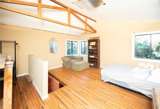 bedroom featuring vaulted ceiling and wood-type flooring