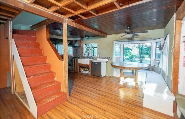 interior space with ceiling fan, wood ceiling, and hardwood / wood-style floors