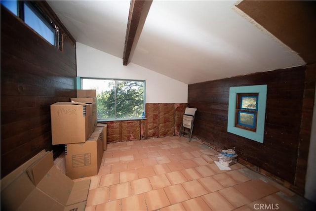 bonus room featuring wooden walls and vaulted ceiling with beams