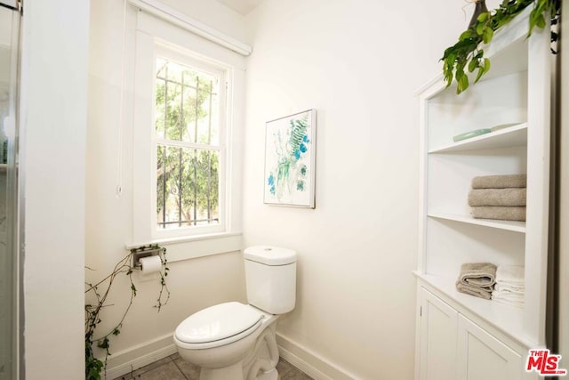 bathroom featuring tile patterned flooring and toilet