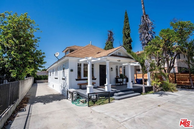 back of property with a pergola and a patio area