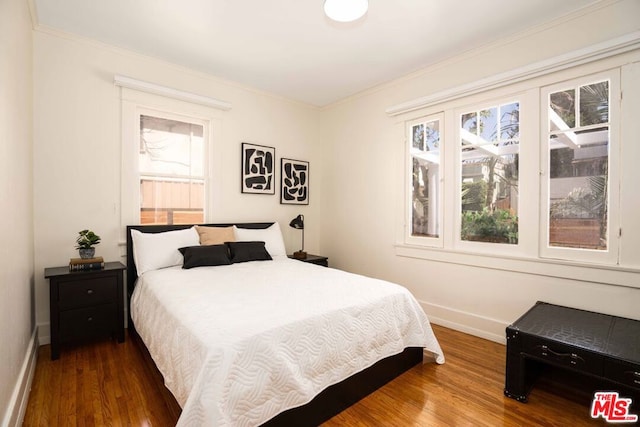 bedroom featuring crown molding and hardwood / wood-style flooring