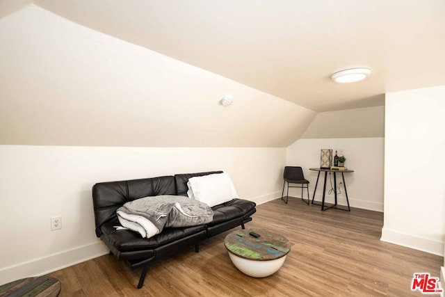 living area with wood-type flooring and lofted ceiling