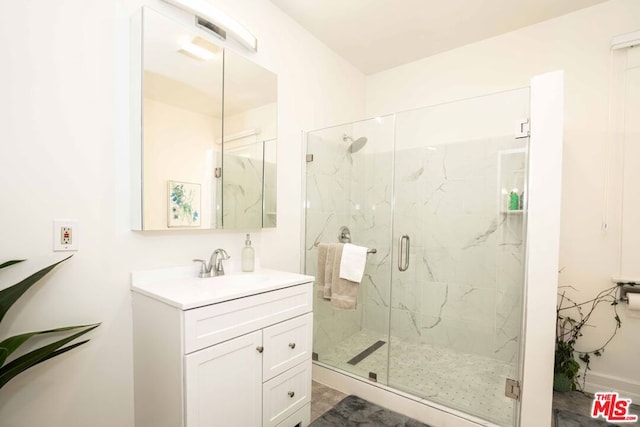 bathroom featuring vanity and an enclosed shower