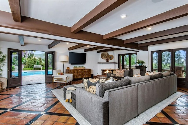 living room featuring beam ceiling, french doors, a healthy amount of sunlight, and tile patterned flooring