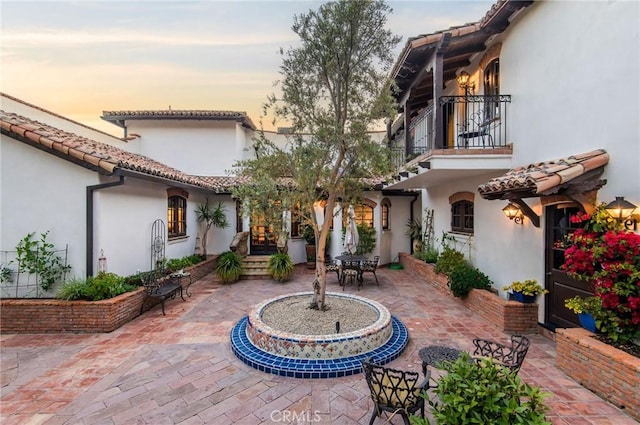 patio terrace at dusk with a balcony