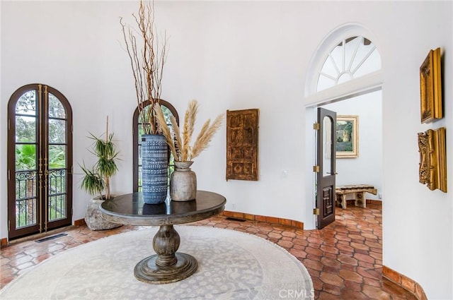 foyer with french doors and a towering ceiling