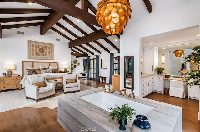 bedroom with beam ceiling, high vaulted ceiling, and hardwood / wood-style flooring