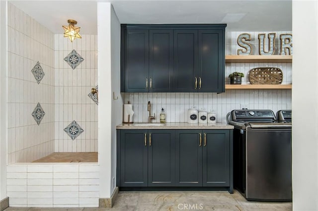 interior space featuring washer and dryer, cabinets, and sink