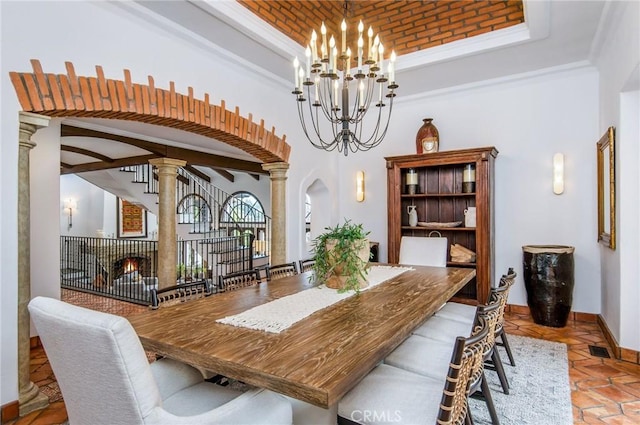 dining area with a chandelier and decorative columns