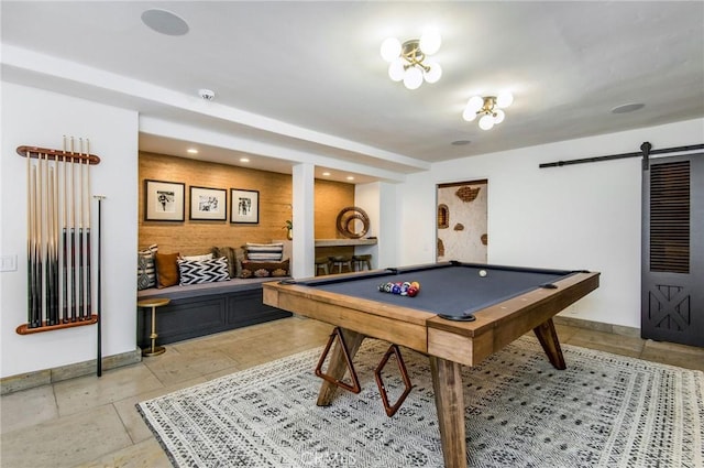 recreation room with a barn door and pool table