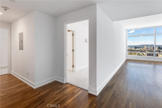 corridor featuring dark hardwood / wood-style flooring and electric panel