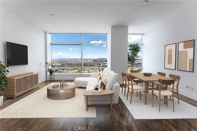 living room with floor to ceiling windows and dark hardwood / wood-style flooring