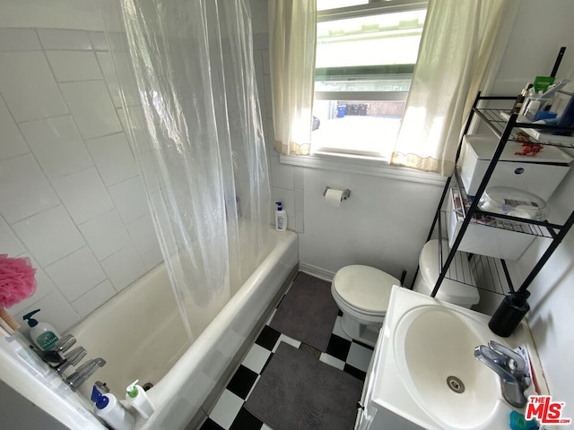 full bathroom featuring shower / bath combo with shower curtain, tile flooring, sink, and toilet