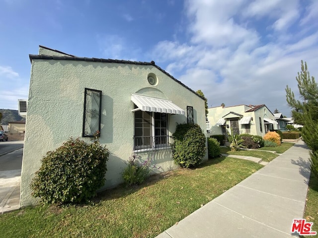 view of home's exterior with a lawn