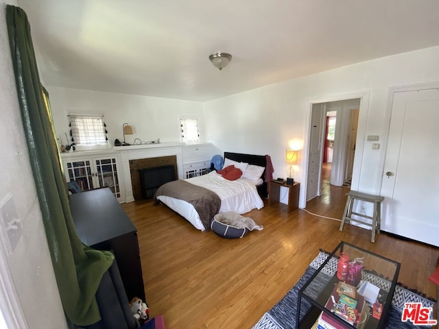 bedroom featuring hardwood / wood-style flooring and multiple windows