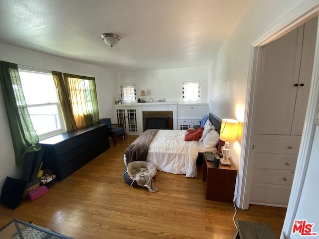 bedroom featuring multiple windows and hardwood / wood-style flooring