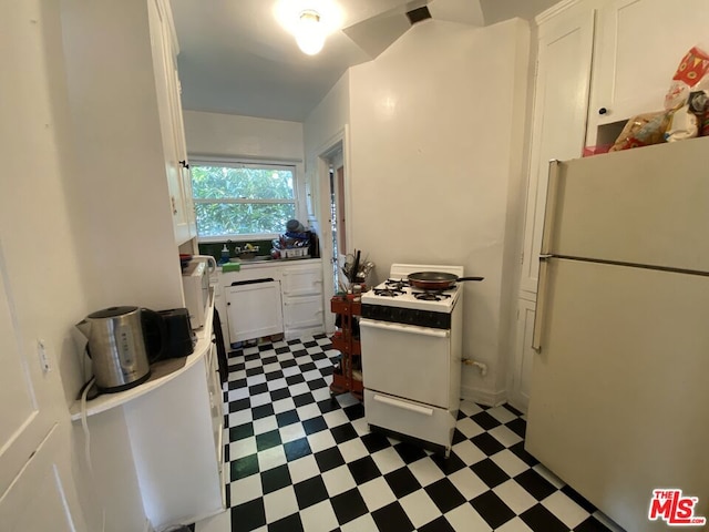 kitchen with white cabinets, white appliances, and light tile floors