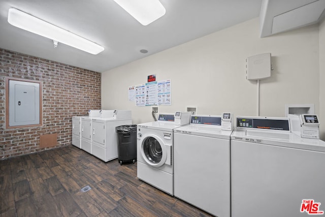 laundry room featuring brick wall, washer and dryer, washer hookup, and dark hardwood / wood-style floors