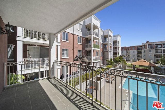 balcony featuring a community pool