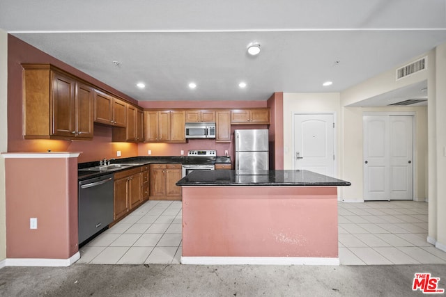 kitchen featuring sink, light tile floors, a kitchen island, and appliances with stainless steel finishes